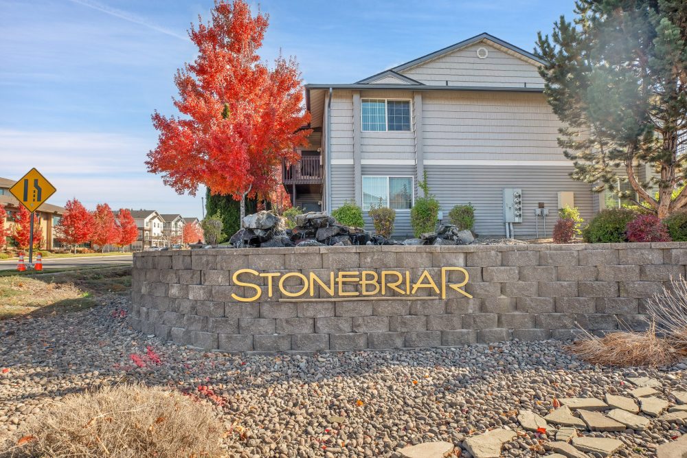Entrance to StoneBriar, showing sign on stone wall with water feature